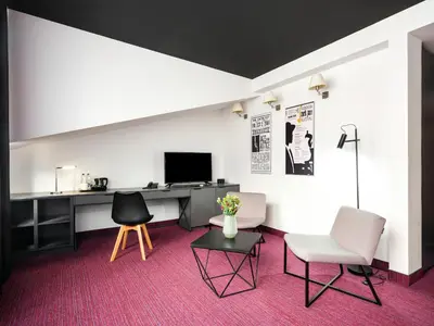 a room with a desk and chairs and a computer at Best Western Plus Krakow Old Town in Kraków