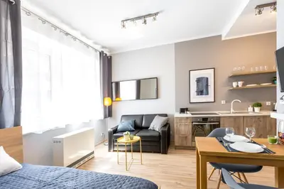 a small living room with a couch and a table at Friendhouse Apartments Avenue in Kraków
