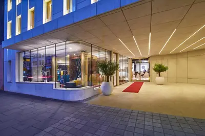 a lobby of a building with two potted plants at INX Design Hotel in Kraków