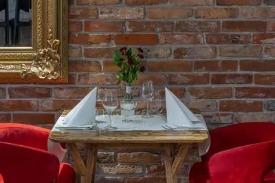 a table with glasses and a paper envelope on it at INX Design Hotel in Kraków