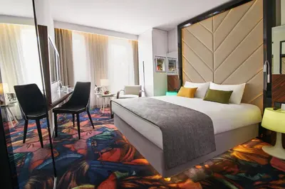 a hotel room with a large bed and a desk at INX Design Hotel in Kraków