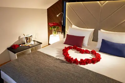 a bed with a heart made out of red roses at INX Design Hotel in Kraków