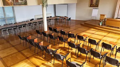 an empty lecture hall with chairs and a podium at Pastoral Lodge at the Sanctuary of the Divine Mercy in Kraków