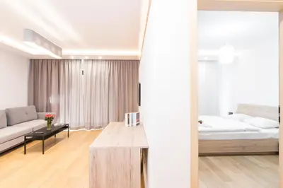 a living room with a couch and a bed at CityHeaven with parking and AC in Kraków