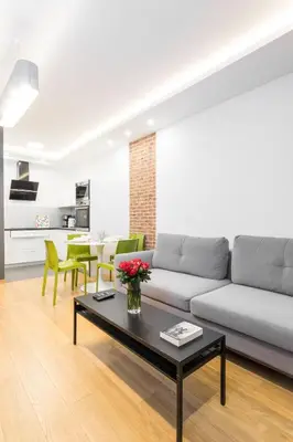 a living room with a couch and a table at CityHeaven with parking and AC in Kraków