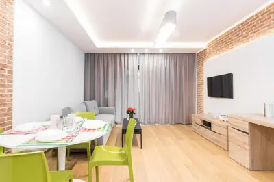 a dining room with a table and green chairs at CityHeaven with parking and AC in Kraków