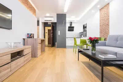 a living room with a couch and a table at CityHeaven with parking and AC in Kraków