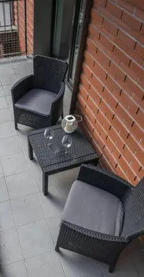 a patio with two chairs and a table and a chair at CityHeaven with parking and AC in Kraków