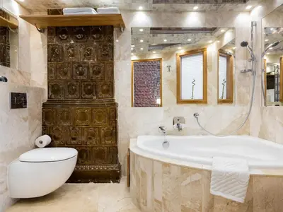 a bathroom with a tub and a toilet and a sink at Aparthotel Stare Miasto in Kraków