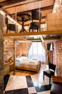 a bedroom with a bed in a brick wall at Aparthotel Stare Miasto in Kraków