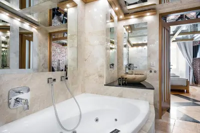 a large bathroom with a tub and a sink at Aparthotel Stare Miasto in Kraków