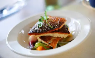 a white plate of food on a table at Aparthotel Stare Miasto in Kraków