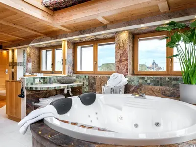 a bathroom with a large white bath tub at Aparthotel Stare Miasto in Kraków