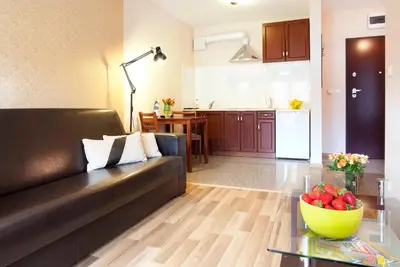 a living room with a couch and a table at Cracow Stay Apartments in Kraków