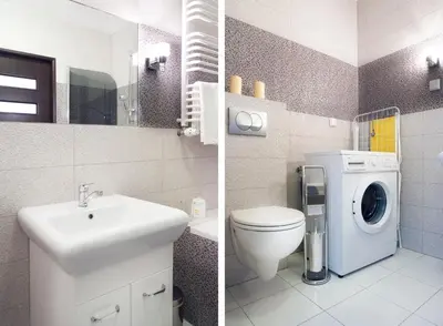 a bathroom with a toilet sink and a washing machine at Cracow Stay Apartments in Kraków