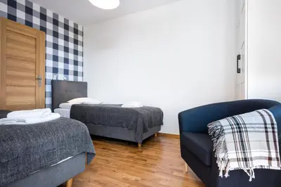 a living room with two beds and a couch at JT Apartments/Dworska in Kraków