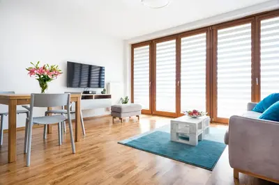 a living room with a table and a dining room at JT Apartments/Dworska in Kraków