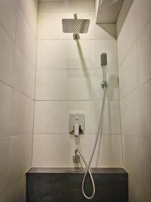 a shower with a shower head in a bathroom at JT Apartments/Dworska in Kraków