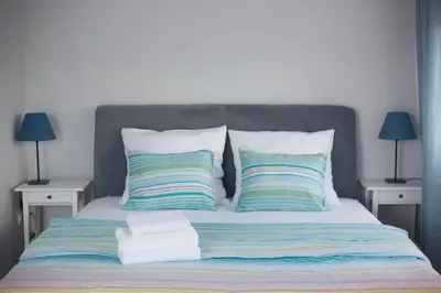 a bed with two pillows and towels on it at Podzamcze in Rożnów