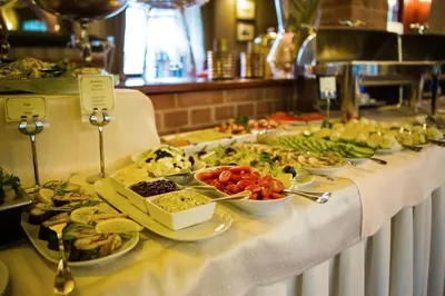 a buffet line with plates of food on a table at Hotel Galicja Superior Wellness & Spa in Oświęcim
