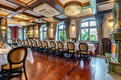 a dining room with a long table and chairs at Hotel Galicja Superior Wellness & Spa in Oświęcim