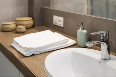 a bathroom counter with a sink and a mirror at Słowackiego 11B - cozy studio by Homeprime in Kraków