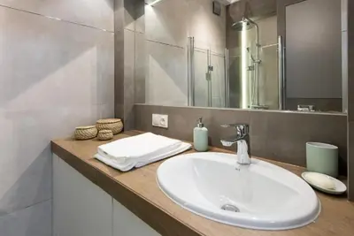 a bathroom with a sink and a mirror at Słowackiego 11B - cozy studio by Homeprime in Kraków