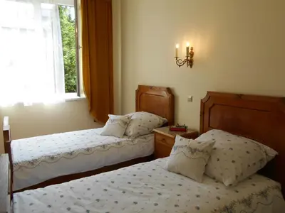 a bedroom with two beds and a window at Apartament Krakowski Styl in Kraków
