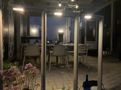 a dining room with a table and chairs at night at Bed&Breakfast Mikunda in Chrzanów