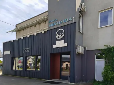a building with a sign on the front of it at Bed&Breakfast Mikunda in Chrzanów