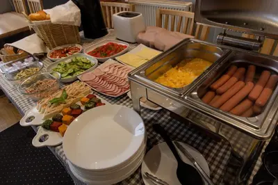 a table with a buffet of food on a table at Bed&Breakfast Mikunda in Chrzanów