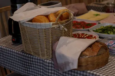 a basket of bread and other food on a table at Bed&Breakfast Mikunda in Chrzanów