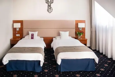a hotel room with two beds and a window at ParkHotel Łysoń in Inwałd