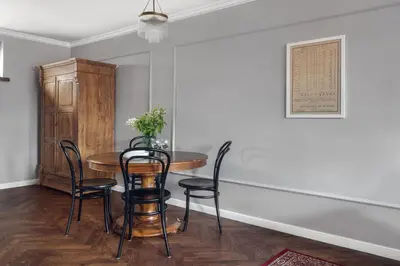 a dining room with a table and chairs at Apartamenty Józefa Kazimierz in Kraków