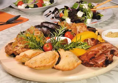 a plate of food with meat and a salad at Pokoje U Filipa in Kraków