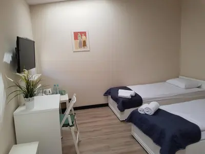 a small room with two beds and a desk at Pokoje U Filipa in Kraków