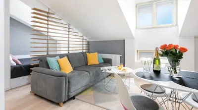 a living room with a couch and a table at Topolowa Apartment, next to Main Station in Kraków