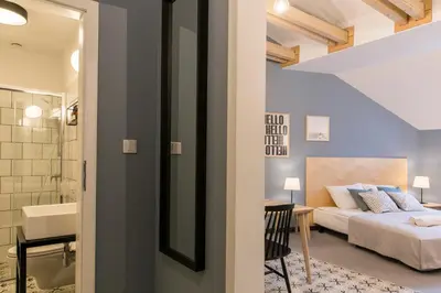 a bedroom with a bed and a bathroom at 19Rooms in Kraków