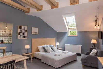 a bedroom with a bed and a couch and a table at 19Rooms in Kraków