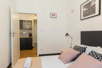 a bedroom with a white bed with pillows at 19Rooms in Kraków