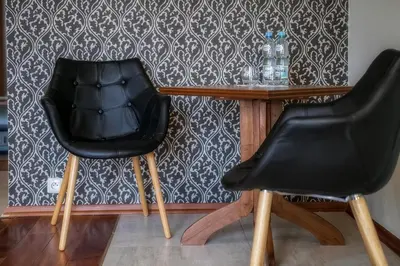two black chairs sitting next to a wooden table at Pokoje na stoku Czarny Groń in Rzyki