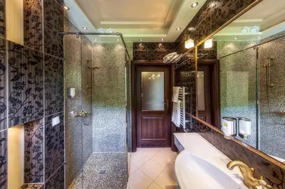 a bathroom with a tub and a shower and a sink at Pokoje na stoku Czarny Groń in Rzyki