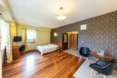 a room with a bed and a table and chairs at Pokoje na stoku Czarny Groń in Rzyki