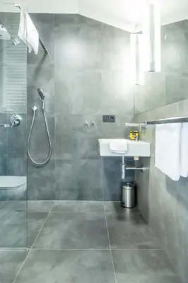 a bathroom with a shower and a sink at Krakow Central Apartments in Kraków