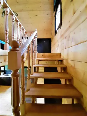 a staircase in a log cabin with a stair case at Domki,,Chatki Góralskie 