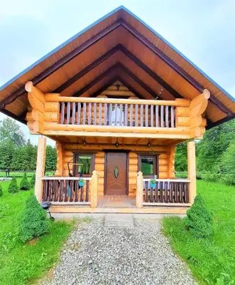 a large wooden cabin with a large deck at Domki,,Chatki Góralskie 