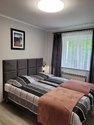 a bedroom with two beds and a window at Zajazd Wernyhora in Sułoszowa