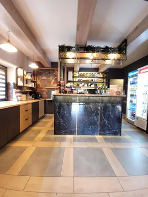 a large kitchen with a counter and a bar at Zajazd Wernyhora in Sułoszowa