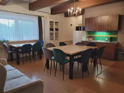a kitchen and dining room with a table and chairs at Zajazd Wernyhora in Sułoszowa