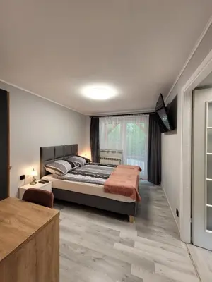 a bedroom with a bed and a large window at Zajazd Wernyhora in Sułoszowa